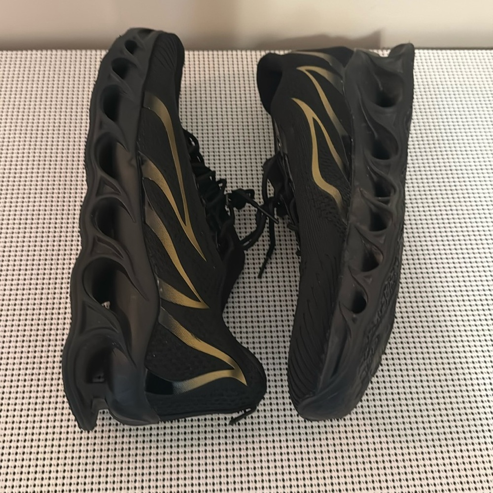 Brand new men’s black and gold sneakers